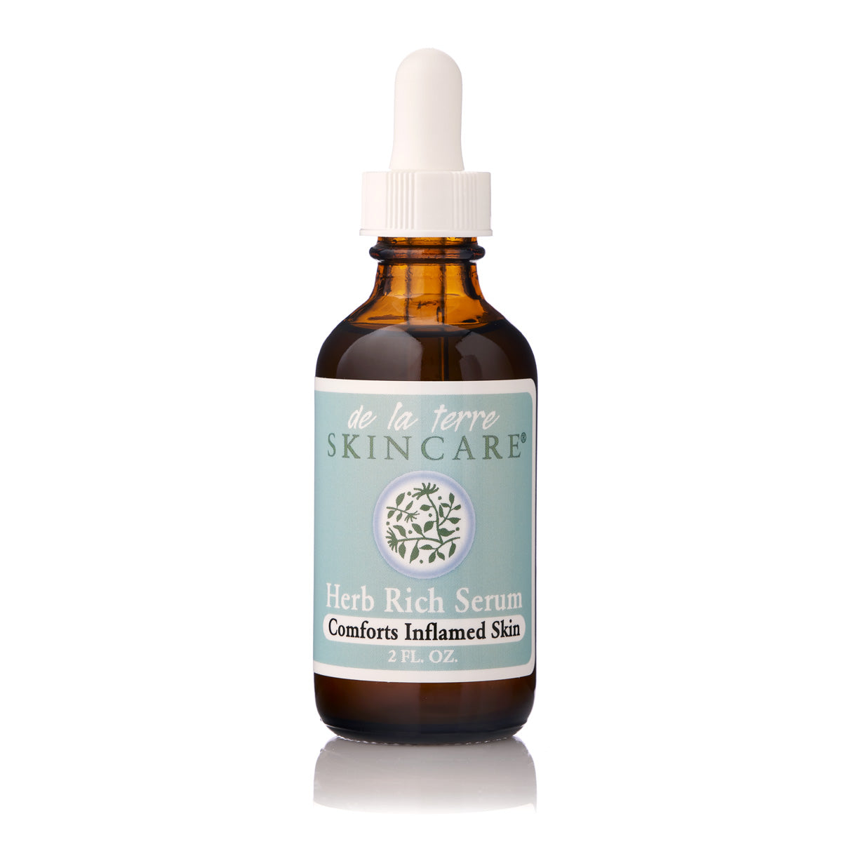“De La Terre Skincare Herb Rich Serum in amber glass dropper bottle with white cap on white background”
