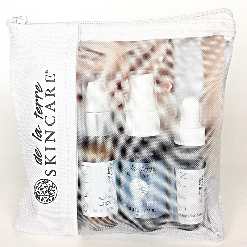 “Purifies Daily Essential Kit with three Herb Rich skincare bottles packaged in a De La Terre Skincare zip pouch”