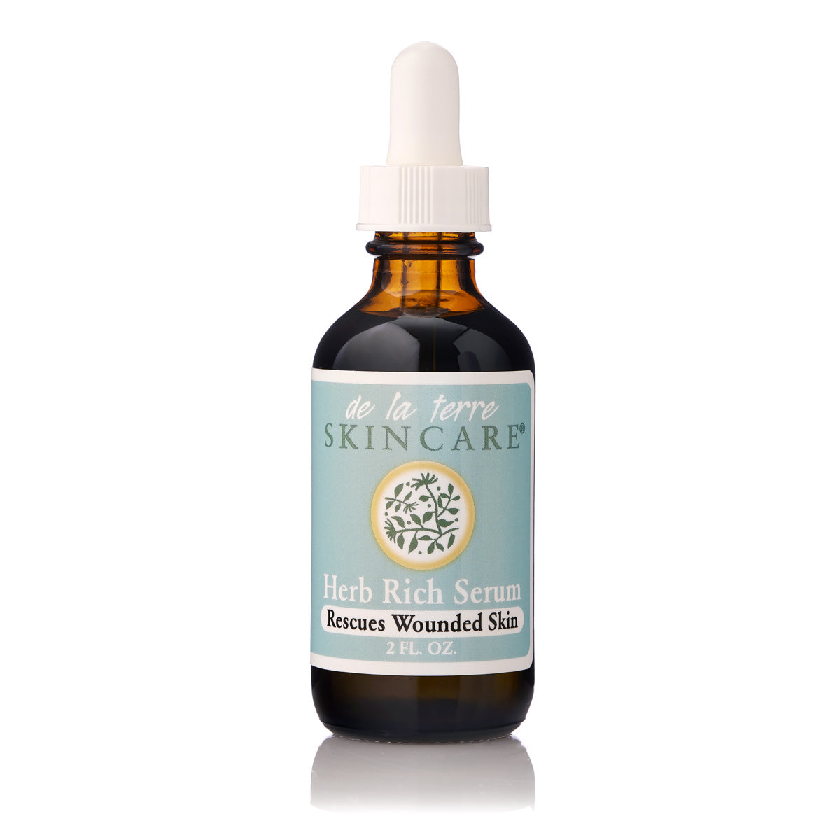 “De La Terre Skincare Herb Rich Serum in amber glass dropper bottle with white cap on white background”