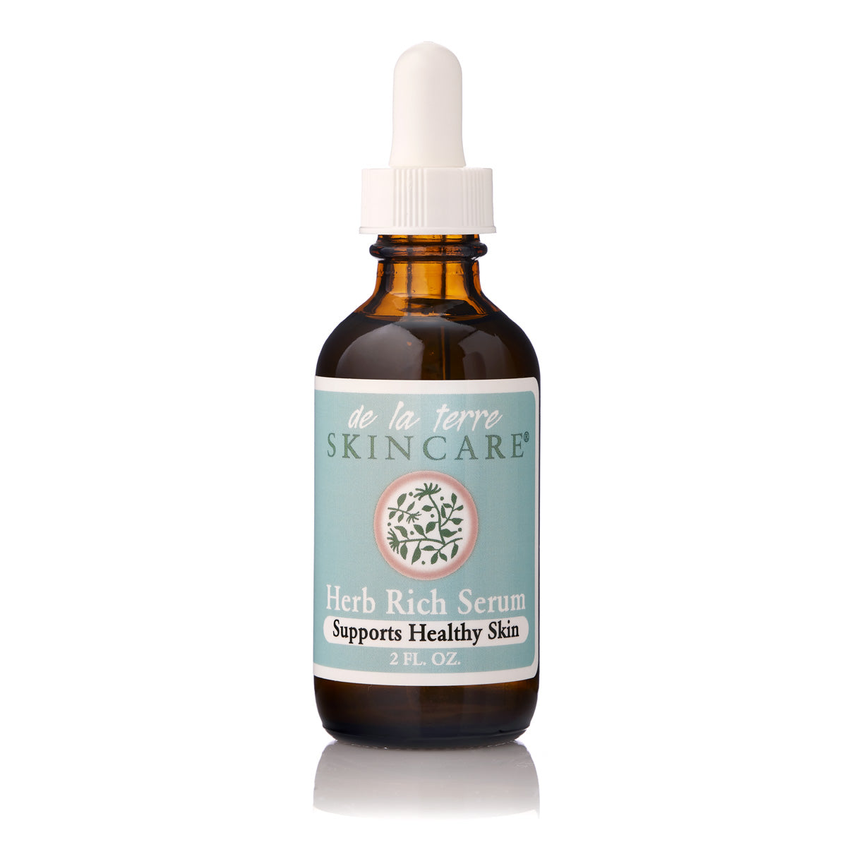 “De La Terre Skincare Herb Rich Serum in amber glass dropper bottle with white cap on white background”